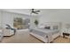 Serene bedroom with light colors, backyard view, and cozy seating for a relaxing retreat at 702 N Sweetwater Blvd, Longwood, FL 32779