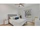 Cozy bedroom with a queen bed, neutral tones, and a window overlooking lush greenery at 702 N Sweetwater Blvd, Longwood, FL 32779