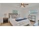 Comfortable bedroom with a plush bed, stylish decor, and ample natural light from two windows at 702 N Sweetwater Blvd, Longwood, FL 32779