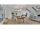 Bright open-concept dining and living area with hardwood floors, fireplace, and modern decor at 702 N Sweetwater Blvd, Longwood, FL 32779