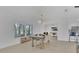 Bright and airy dining area with ample seating and views into the home office and kitchen at 702 N Sweetwater Blvd, Longwood, FL 32779
