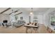 Open-concept living and dining area with modern furnishings and hardwood floors at 702 N Sweetwater Blvd, Longwood, FL 32779