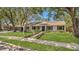 Charming single-story home with a well-manicured lawn, mature trees, and inviting curb appeal at 702 N Sweetwater Blvd, Longwood, FL 32779
