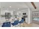Modern kitchen with white cabinets, stainless steel appliances, and a breakfast bar overlooking the pool at 702 N Sweetwater Blvd, Longwood, FL 32779