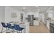 Bright, modern kitchen with white cabinetry, stainless steel appliances, and a center island with seating at 702 N Sweetwater Blvd, Longwood, FL 32779