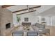 Inviting living room featuring a brick fireplace, beamed ceiling, and contemporary decor at 702 N Sweetwater Blvd, Longwood, FL 32779