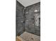 Modern shower with gray subway tile, grab bar, and patterned tile floor at 702 N Sweetwater Blvd, Longwood, FL 32779