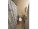 Neutral bathroom featuring a patterned shower curtain, toilet, and a vanity with a mirrored medicine cabinet at 710 Ridenhour Cir # 710, Orlando, FL 32809