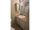 Modest bathroom with vanity, mirrored cabinet, toilet, and shower featuring neutral color scheme at 710 Ridenhour Cir # 710, Orlando, FL 32809