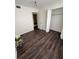 Bedroom featuring new laminate flooring, and a spacious closet with a white flower decoration at 710 Ridenhour Cir # 710, Orlando, FL 32809