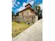 Condominium complex entrance with stone signage, landscaping, and fountain feature at 710 Ridenhour Cir # 710, Orlando, FL 32809