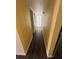 Hallway with wood look flooring leading to a bathroom at 710 Ridenhour Cir # 710, Orlando, FL 32809