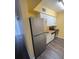 Well-lit kitchen features modern stainless steel appliances and ample cabinet storage at 710 Ridenhour Cir # 710, Orlando, FL 32809