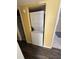 A stacked washer and dryer tucked away in a yellow painted laundry nook at 710 Ridenhour Cir # 710, Orlando, FL 32809