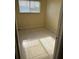 Small vacant room with tiled floors, window, and neutral paint at 710 Ridenhour Cir # 710, Orlando, FL 32809