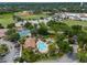 Overhead shot of the pool, tennis court, baseball field, and clubhouse in a picturesque community at 7449 Sugar Bend Dr # 7449, Orlando, FL 32819