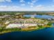 Aerial view of shopping and businesses near the lake offering a variety of goods and services at 7449 Sugar Bend Dr # 7449, Orlando, FL 32819