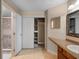 Bathroom featuring tiled floors, closet, vanity with sink, and shower with stylish tile surround open at 7449 Sugar Bend Dr # 7449, Orlando, FL 32819