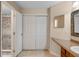 Bathroom featuring tiled floors, closet, vanity with sink, and shower with stylish tile surround at 7449 Sugar Bend Dr # 7449, Orlando, FL 32819
