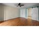 Bright bedroom featuring hardwood floors, a ceiling fan, and closet space at 7449 Sugar Bend Dr # 7449, Orlando, FL 32819