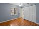 Bedroom featuring a window with blinds, hardwood floor, and closet with bi-fold doors at 7449 Sugar Bend Dr # 7449, Orlando, FL 32819