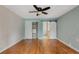 Open bedroom featuring hardwood floors, a ceiling fan, and closet space at 7449 Sugar Bend Dr # 7449, Orlando, FL 32819
