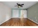 Spacious bedroom with hardwood floors and a ceiling fan at 7449 Sugar Bend Dr # 7449, Orlando, FL 32819