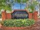 Welcoming community entrance sign for Sanctuary at Bay Hill, enhanced by lush landscaping at 7449 Sugar Bend Dr # 7449, Orlando, FL 32819