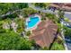 Aerial view of a community pool with seating, surrounded by lush landscaping at 7449 Sugar Bend Dr # 7449, Orlando, FL 32819