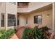 Exterior entryway featuring a garden, neutral color scheme, and access to a unit doorway at 7449 Sugar Bend Dr # 7449, Orlando, FL 32819
