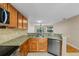 Open-concept kitchen with granite countertops, stainless appliances, and a breakfast bar at 7449 Sugar Bend Dr # 7449, Orlando, FL 32819