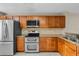 Well-equipped kitchen with stainless steel appliances and wood cabinets at 7449 Sugar Bend Dr # 7449, Orlando, FL 32819