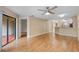 Spacious living room with hardwood floors, ceiling fan, and sliding glass doors to outdoor space at 7449 Sugar Bend Dr # 7449, Orlando, FL 32819