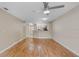 Open-concept living area with hardwood floors, ceiling fan, and view to the kitchen area at 7449 Sugar Bend Dr # 7449, Orlando, FL 32819