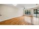 Inviting living room with hardwood floors, neutral walls, ceiling fan, and natural light from a sliding door at 7449 Sugar Bend Dr # 7449, Orlando, FL 32819