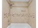Shower features a tub, tiled surround, mosaic accents, and a shower head at 7449 Sugar Bend Dr # 7449, Orlando, FL 32819