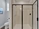 Bathroom featuring a glass enclosed shower, toilet, and window at 7519 Marker Ave, Kissimmee, FL 34747