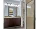 Well-lit bathroom boasts double sinks, granite counters, and a glass enclosed shower at 7519 Marker Ave, Kissimmee, FL 34747