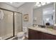 Bathroom featuring granite counters, dark wood cabinets and a glass enclosed shower at 7519 Marker Ave, Kissimmee, FL 34747