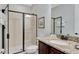 Bathroom featuring granite counters, dark wood cabinets and a glass enclosed shower at 7519 Marker Ave, Kissimmee, FL 34747