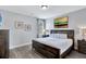 Comfortable bedroom features a dark wood king bed with luxury linens and stylish decor at 7519 Marker Ave, Kissimmee, FL 34747