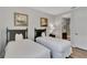 Bright twin bedroom with an adjacent bathroom and nautical decor at 7519 Marker Ave, Kissimmee, FL 34747