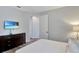 Bright bedroom featuring comfortable bedding, natural light, and a television at 7519 Marker Ave, Kissimmee, FL 34747