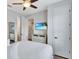 Cozy bedroom with a queen bed, TV, light colored walls, and white trim at 7519 Marker Ave, Kissimmee, FL 34747