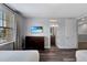 Bedroom with ensuite bath access, dresser, wood-look floors and window at 7519 Marker Ave, Kissimmee, FL 34747