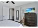 Comfortable bedroom with a ceiling fan, television, and ensuite bathroom at 7519 Marker Ave, Kissimmee, FL 34747