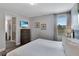 Bright bedroom with a mounted television and a view to a bathroom through the doorway at 7519 Marker Ave, Kissimmee, FL 34747