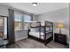 Bedroom featuring bunk beds, wood-look floors and a window at 7519 Marker Ave, Kissimmee, FL 34747