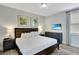 Comfortable bedroom with large headboard, flat screen TV, and wood floors at 7519 Marker Ave, Kissimmee, FL 34747