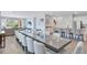 Open floor plan featuring a dining room with a long table and living room with sliding glass doors at 7519 Marker Ave, Kissimmee, FL 34747
